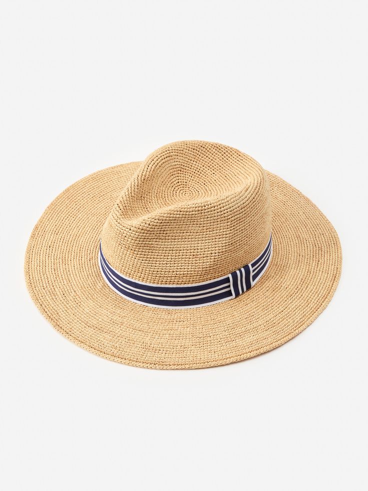 Our Freida Raffia hat is your perfect companion for the beach, horseback riding, or walks around town, or just when you just want an excuse to wear a really chic hat. | J.McLaughlin Women's Freida Raffia Hat Natural/Navy Chic Travel Fedora With Curved Brim, Chic Woven Travel Hat, Chic Fedora Hat For Travel, Chic Travel Fedora Hat, Chic Travel Hats For Kentucky Derby, Chic Travel Hats With Upf 50+, Chic Kentucky Derby Straw Hat For Travel, Chic Kentucky Derby Travel Hat, Wide Brim Woven Fedora For Travel