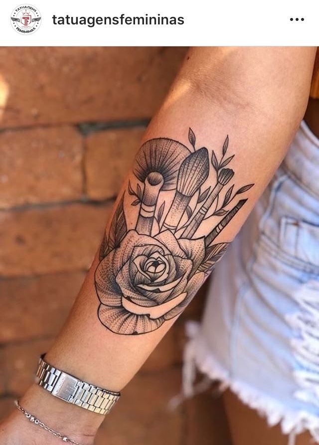 a woman's arm with a black and white rose tattoo on the left forearm