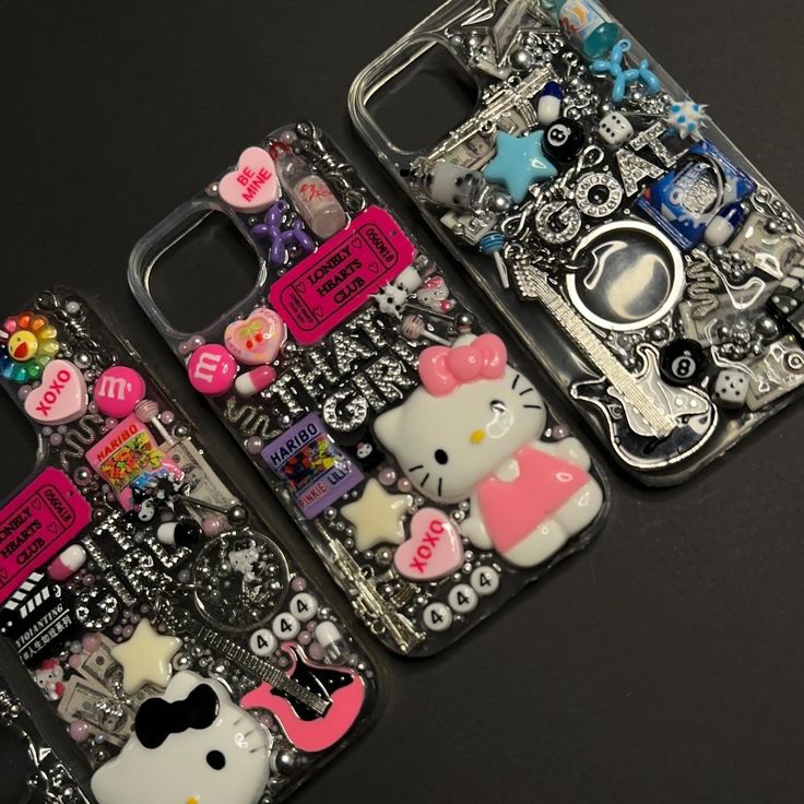 three cell phones decorated with hello kitty and other things on them, all covered in different designs