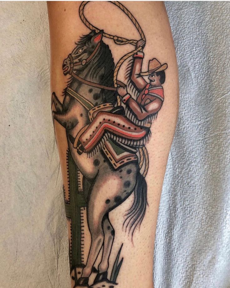 a tattoo on the leg of a man with a horse and rider in it's body