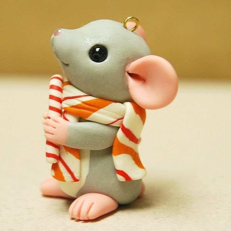 a small toy mouse with a scarf around it's neck