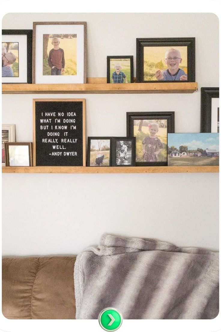 some pictures are hanging on the wall above a couch