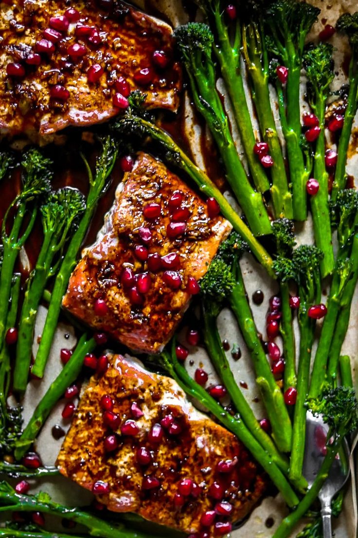 salmon and broccoli with pomegranate on a plate