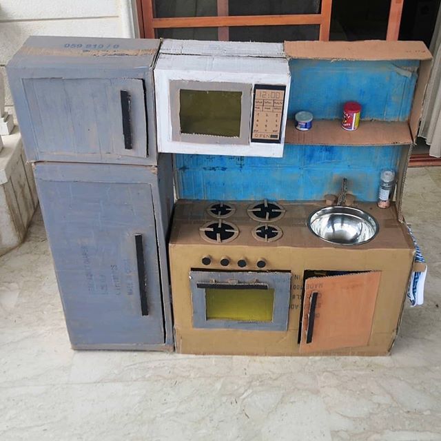 an old toy stove and oven in the shape of a house