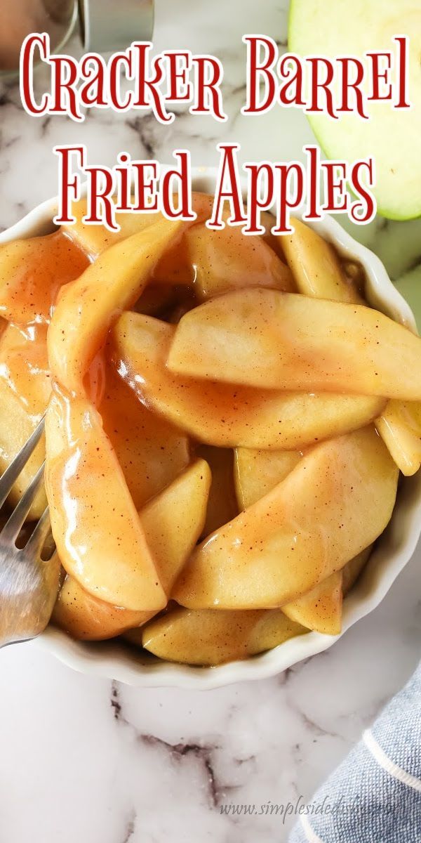 a white bowl filled with sliced apples on top of a marble counter next to a knife and fork