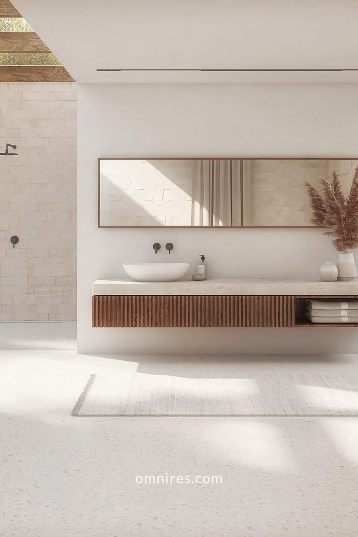 a white bathroom with two sinks and mirrors