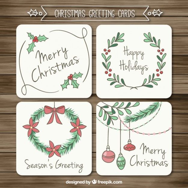 four christmas cards with holly wreaths and ornaments