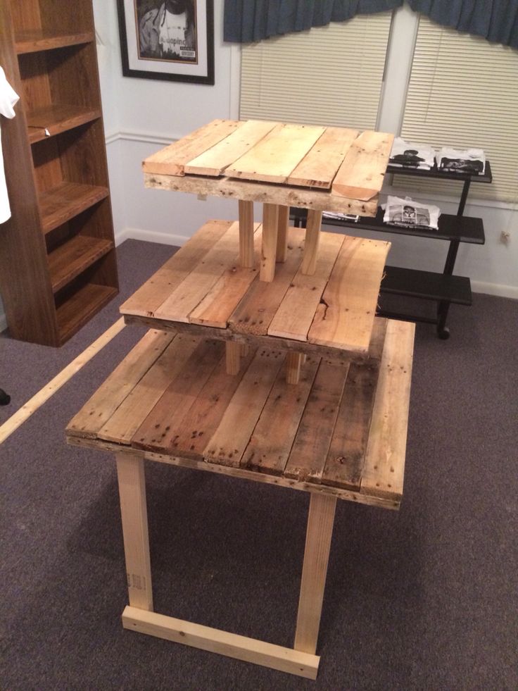 a table made out of wooden pallets in a room with carpeted flooring