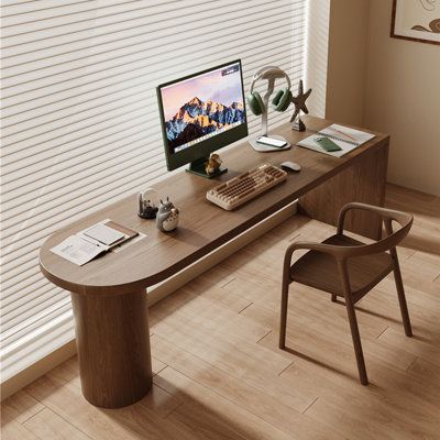 an office desk with a computer and chair in front of the window, along with blinds