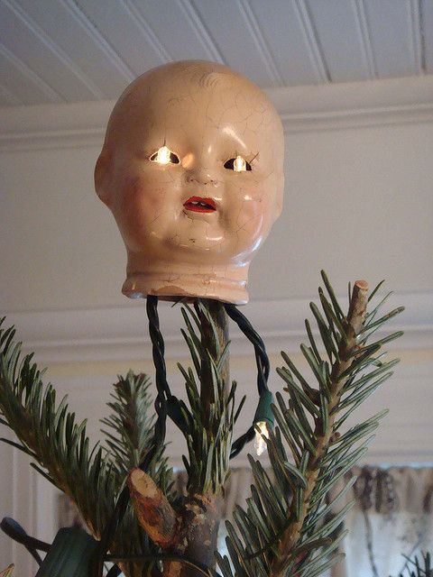 a fake head on top of a christmas tree