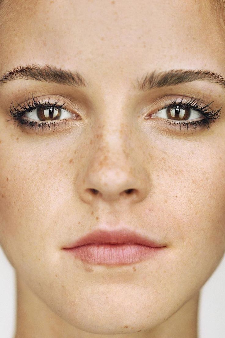 a woman with freckled hair and brown eyes