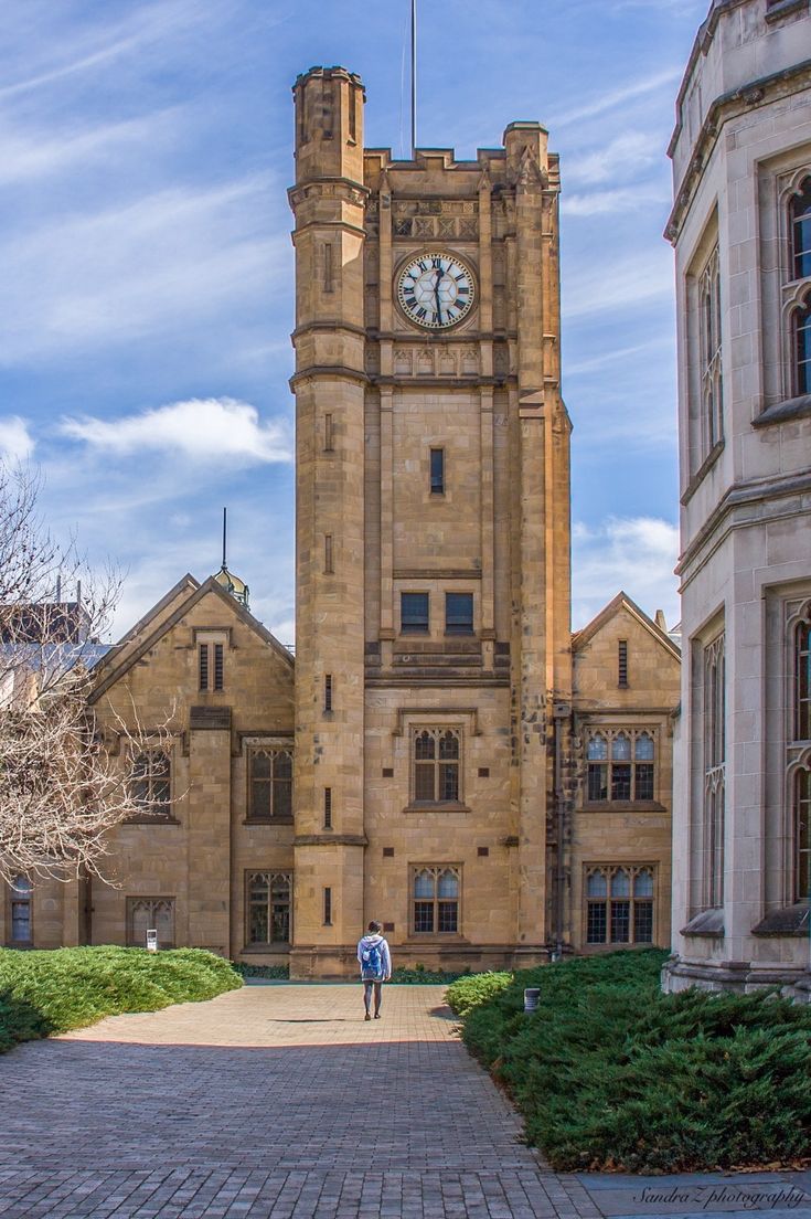 a large building with a clock tower on the side of it's front entrance