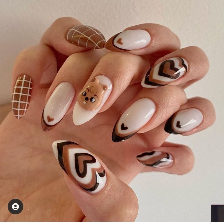 a woman's hand with some white and black nail art