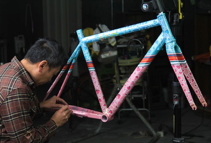 a man is working on a bicycle frame