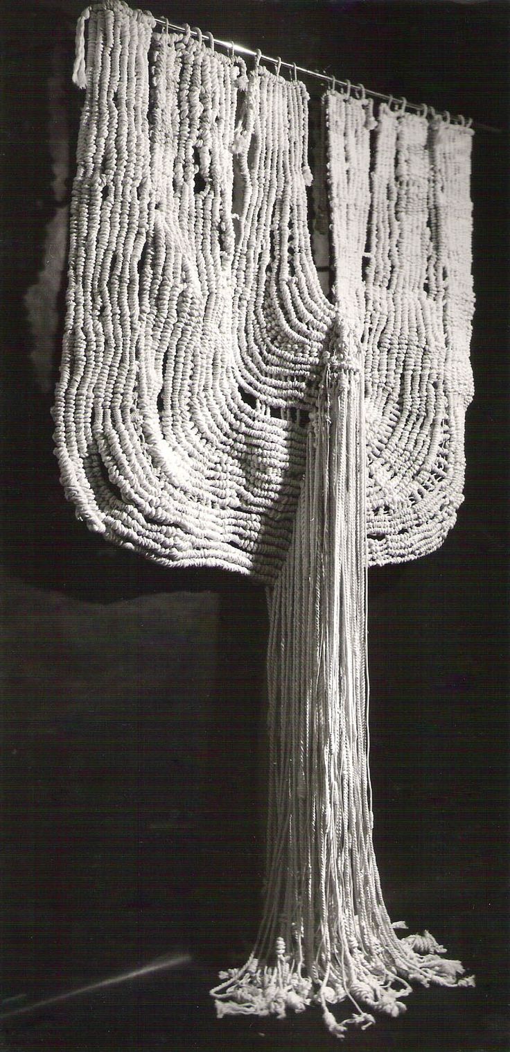 an artistic sculpture made out of string and yarn with fringes hanging from the ceiling