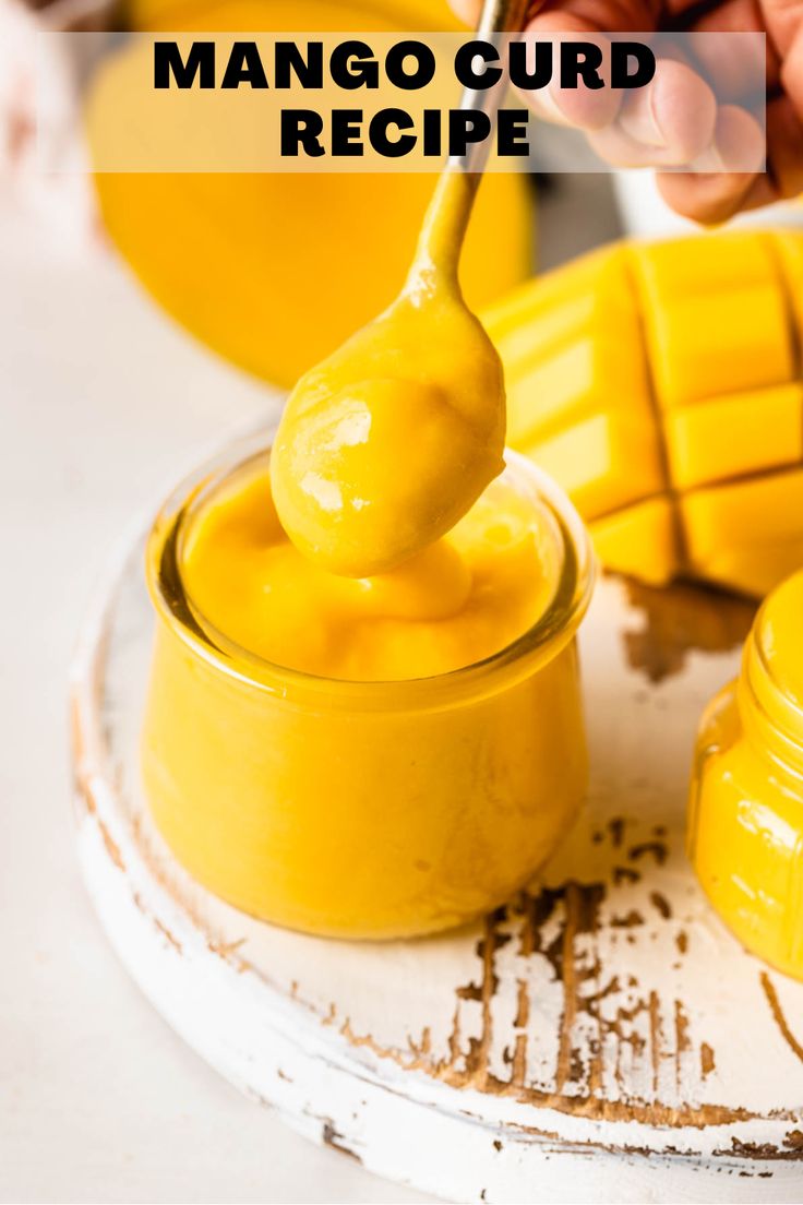 a person dipping mango curd into a jar with a spoon on the side and text overlay reading how to make mango curd recipe