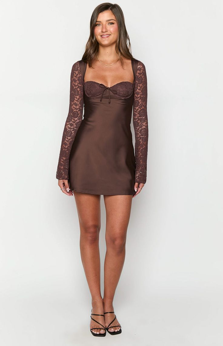 Brown Long Sleeve Mini Dress  How to style: Make a statement in this stunning mini dress () featuring the sweetest lace details! Our Viola Brown Long Sleeve () Mini Dress is perfect for your next night out or date night (). Elevate the classy silhouette with some gold jewellery and strappy heels for a stunning look!  Features:      * Mini length   * Lace overlay on bust   * Tie up centre front   * Underwire bust cups   * Light weight satin body   * Invisible zipper on back   * Lined body and bus Mini Lace Dress For Date Night, Evening Mini Dress With Lace Patchwork, Fitted Coquette Mini Dress With Lace Trim, Fitted Mini Dress With Lace Patchwork For Brunch, Fitted Lace Patchwork Mini Dress For Cocktail, Party Mini Dress With Lace Patchwork, Embroidered Lace Mini Dress, Bodycon Mini Dress With Lace Sleeves, Chic Mini Dress With Lace Bodice