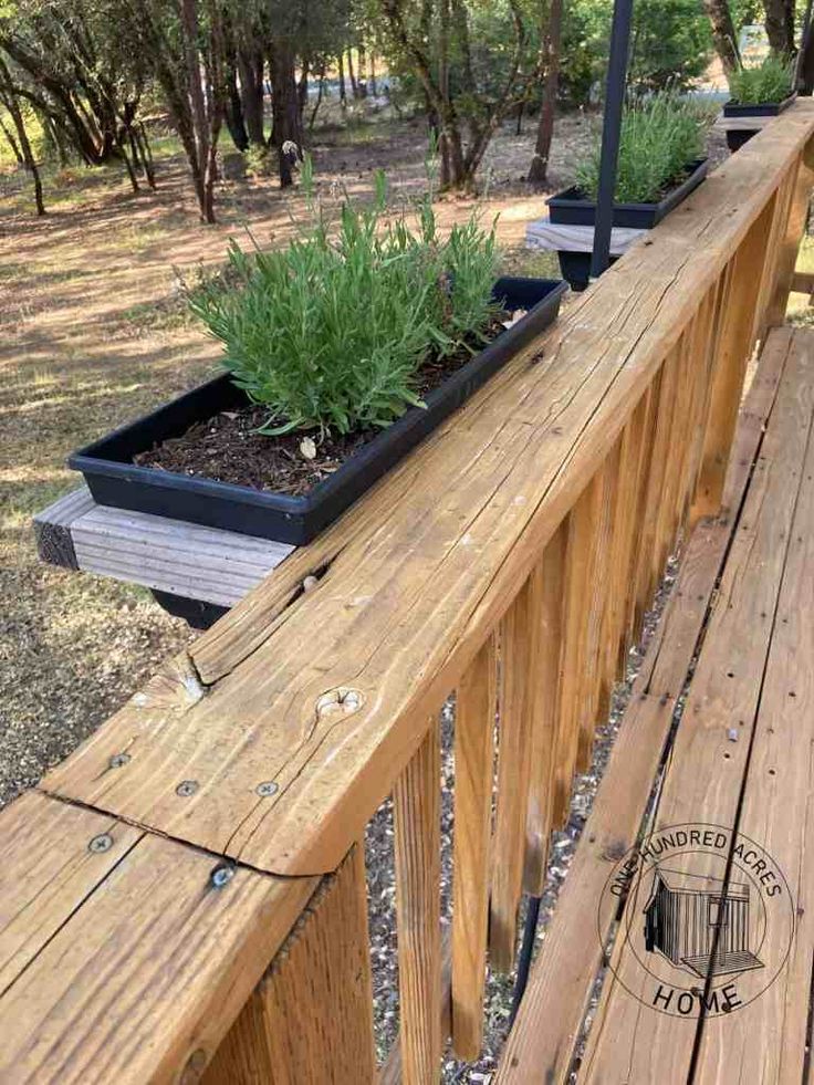 a wooden deck with two planters on it