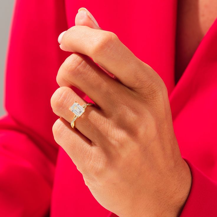 a woman's hand wearing a gold and diamond ring