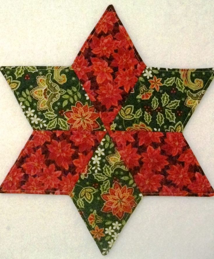 a red and green flowered star on a white wall