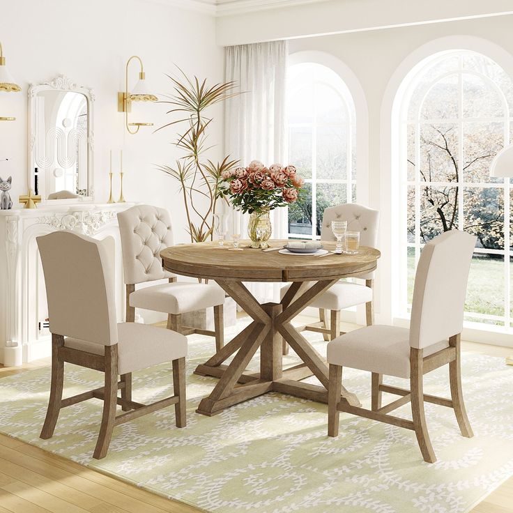 a dining room table with white chairs around it