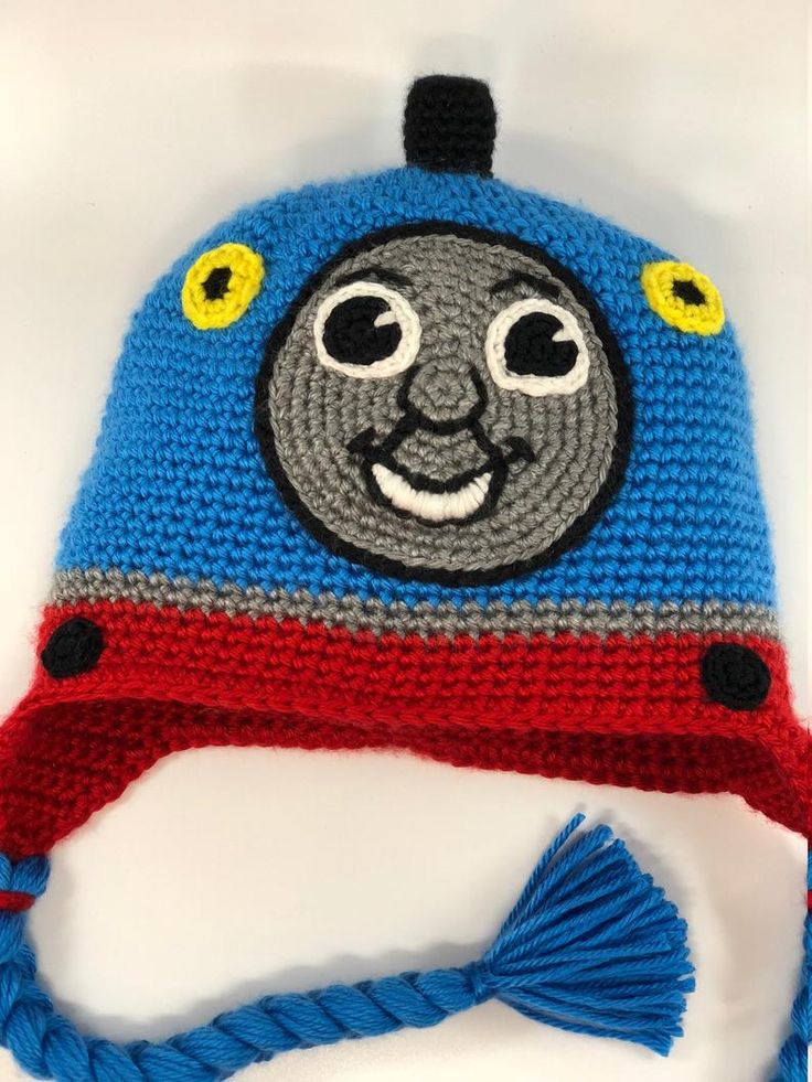 a crocheted thomas the train hat with tassels