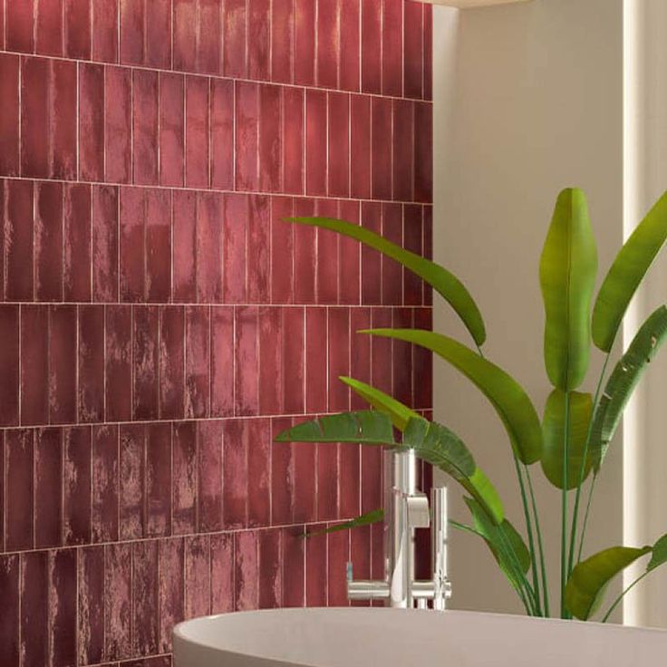 there is a plant in the corner of this bathtub with red tiles on it