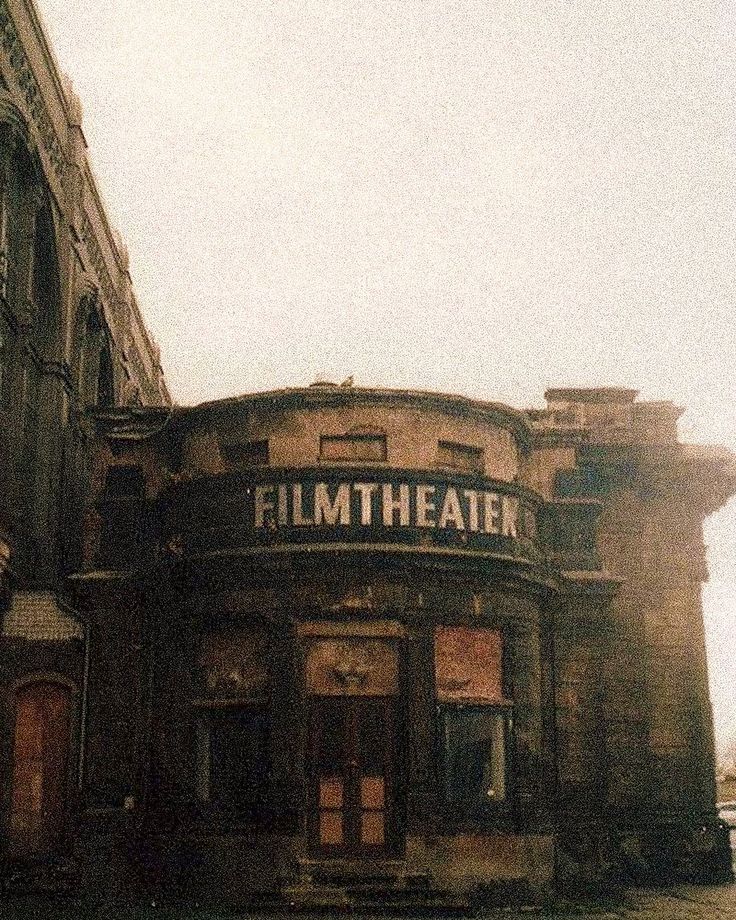 an old building with the word film theater painted on it