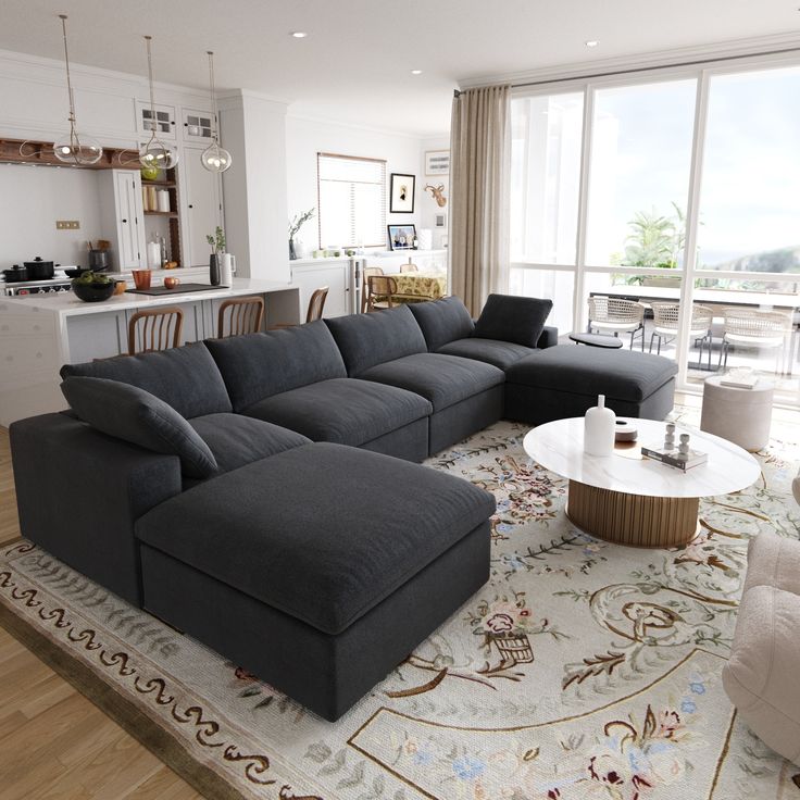 a living room filled with furniture and a large rug on top of a hard wood floor