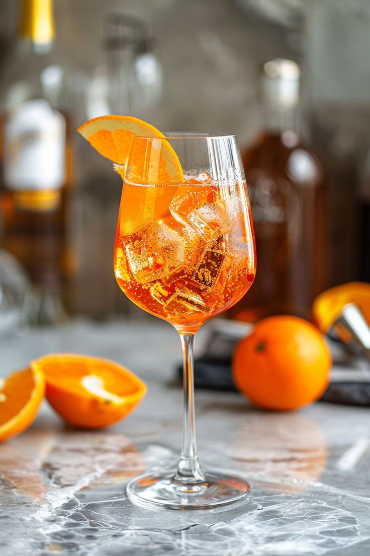 an orange drink in a wine glass with ice