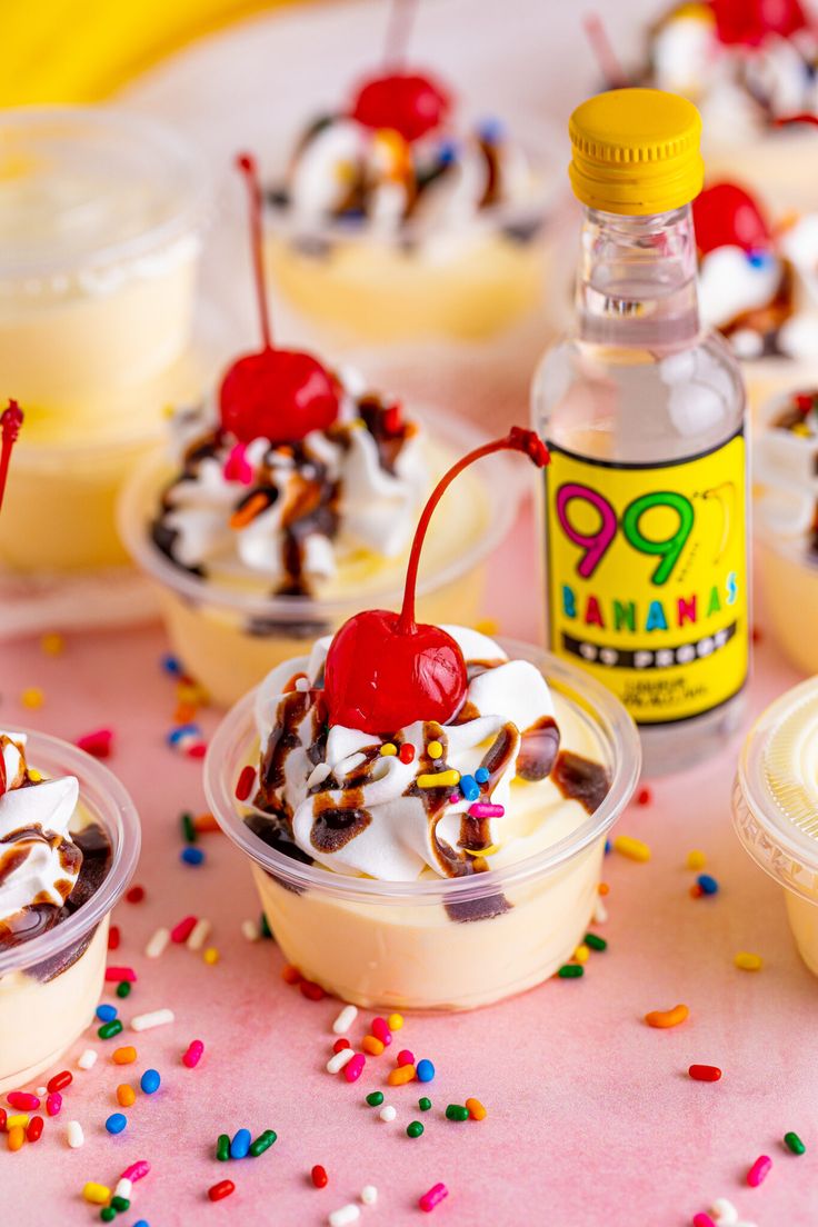 small desserts with ice cream, whipped cream and sprinkles on a table