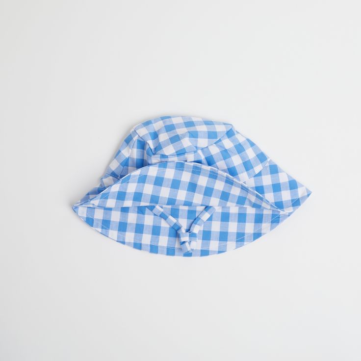 Introducing the Gingham Sunhat! Keep your little one looking stylish and shaded with this fun and fashionable cornflower blue baby sun hat, complete with checkered gingham print that your baby will love. Perfect for a day at the beach or a stylish stroll in the park. Shade in style! Fits ages 6 - 12 months Summer Plaid Bucket Hat, Casual Gingham Hats For Summer, Summer Gingham Hat With Curved Brim, Plaid Curved Brim Hat For Beach, Plaid Curved Brim Hat For The Beach, Summer Plaid Brimmed Hat, Plaid Hats For Summer Beach, Plaid Summer Beach Hat, Adjustable Plaid Hats For Beach