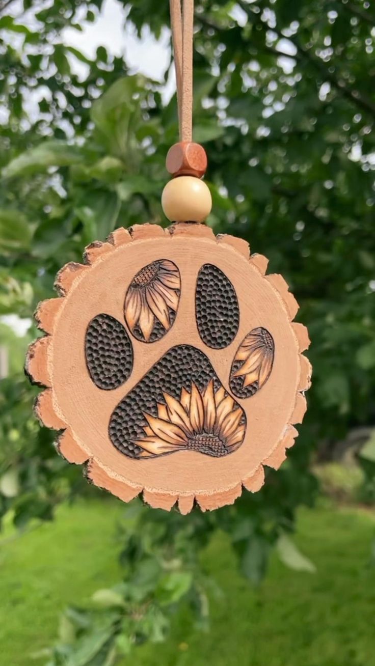 a wooden ornament with an animal's paw painted on it