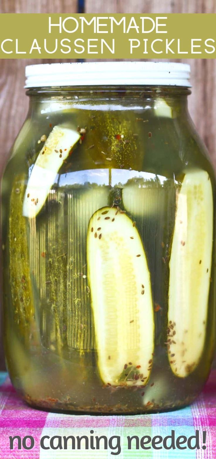 a jar filled with pickles sitting on top of a table