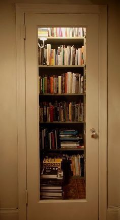 an open book case with books on it in the middle of a room full of books