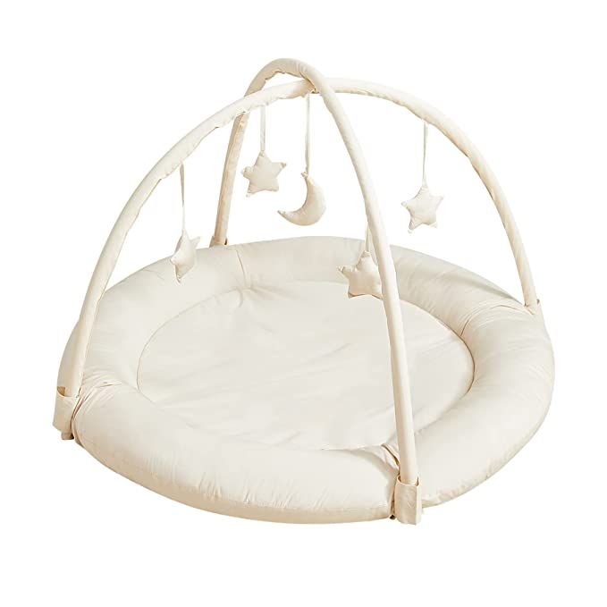 a white baby bed with stars hanging from it's sides and a circular swing