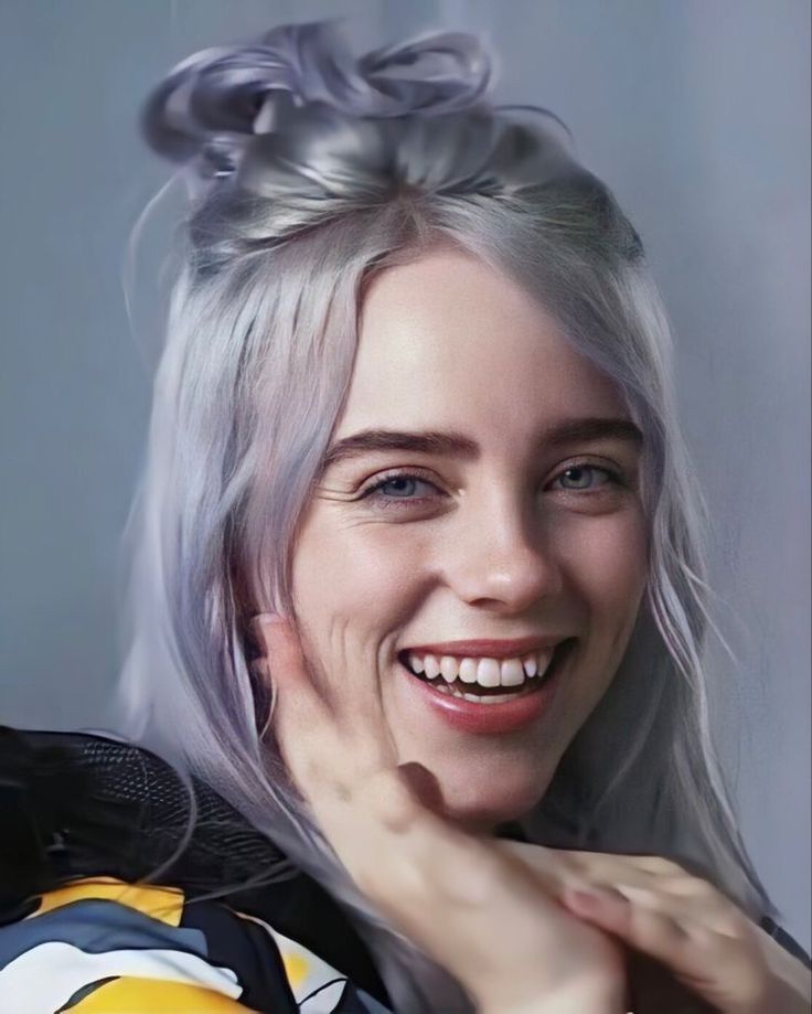 a woman with grey hair smiling at the camera