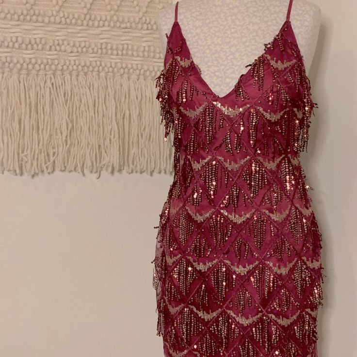 Score This Spicy Burgundy Mini Dress With A Deep V-Neck. The Back Is Relatively Low With Delicate Straps. Some Of The Sequins May Have Fallen Off But It’s Still Got Plenty Of Fire To Burn Down The Town!Wear It To A Salsa Club, Wear It To A Party, For Ya Boo Thing, For That Situationship Thing Either Way You’ll Be A Hottie In This Number. Length: 31”, Waist: Approx 14.5”. Come Check Out My Closet! Great Gatsby Hoco Dresses, Magenta Sequin Dress, Mini Party Dress Night, Holiday Burgundy V-neck Dress, Burgundy V-neck Mini Dress For Summer, Summer Burgundy V-neck Mini Dress, Burgundy V-neck Mini Dress For Party, Glamorous Red V-neck Mini Dress, 20s Fashion Women