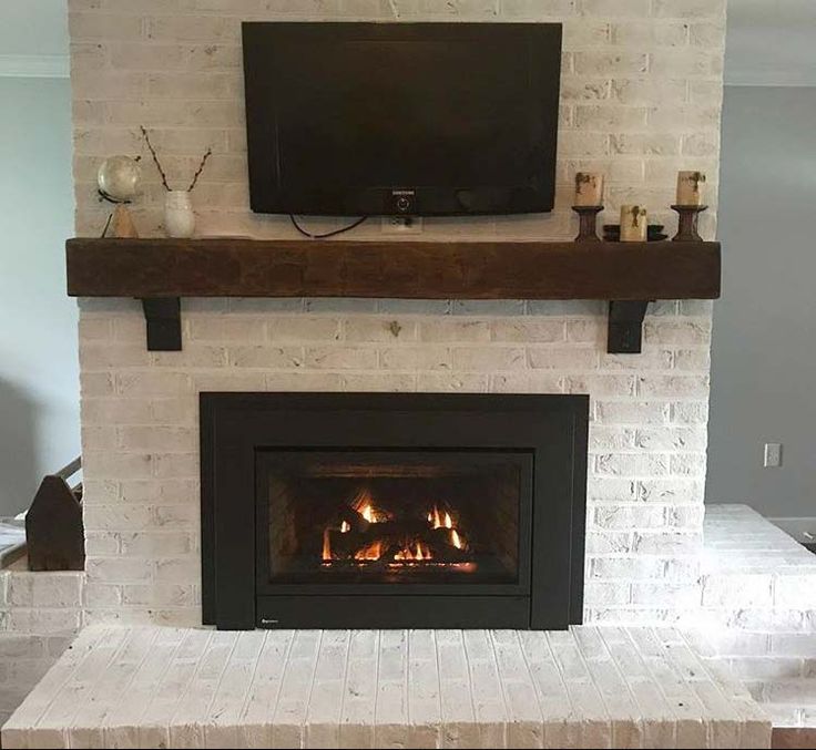 a living room with a fire place and a flat screen tv mounted on the wall