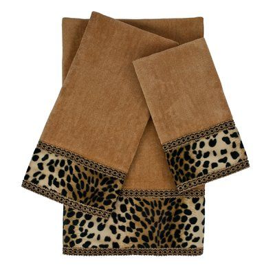 three towels with leopard print on them, one is brown and the other is tan