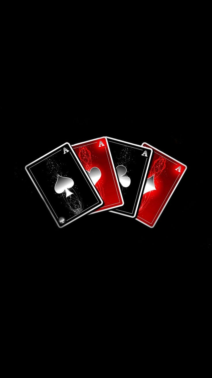 four playing cards with red and black designs on them