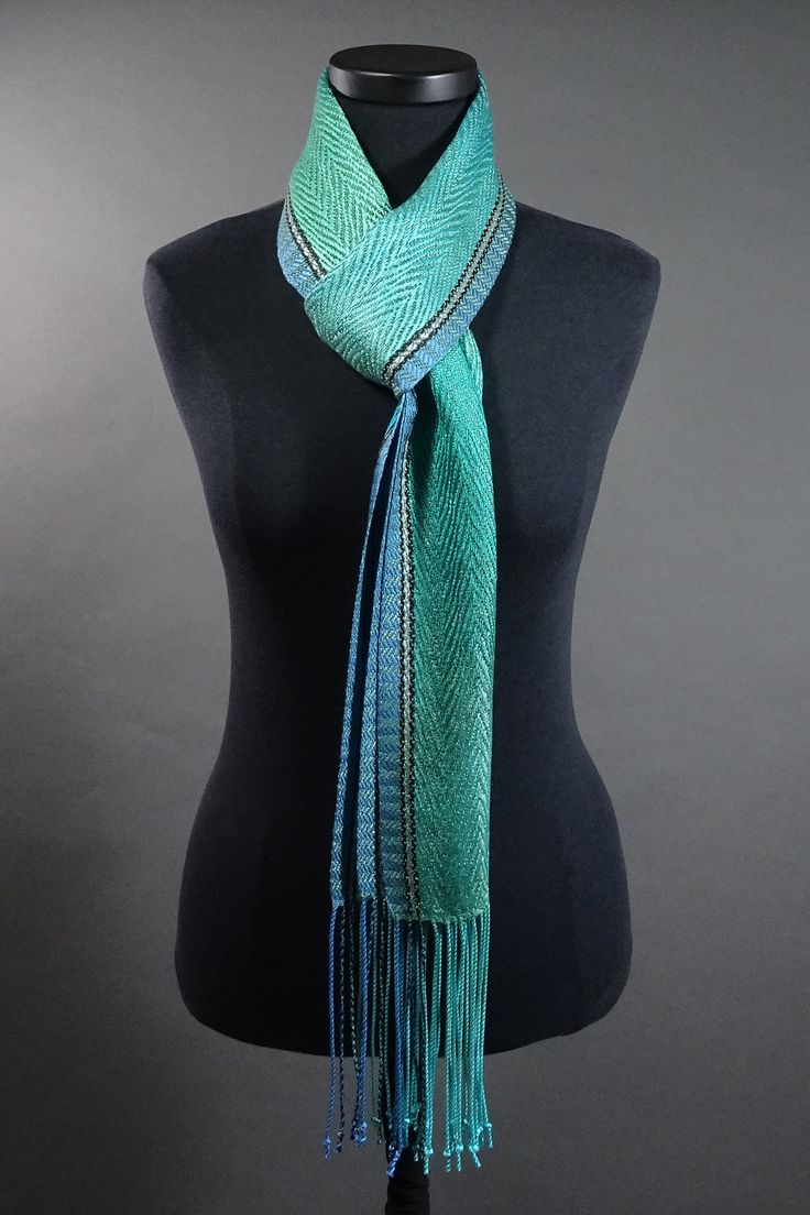 a green and blue scarf on a mannequin