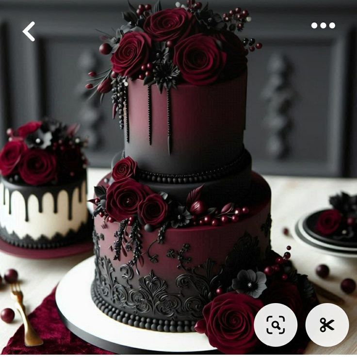 three tiered black and white cake with red roses on top, sitting on a table