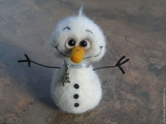 a stuffed snowman is sitting on the ground