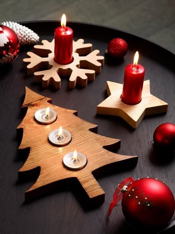 a wooden tray with candles and ornaments on it