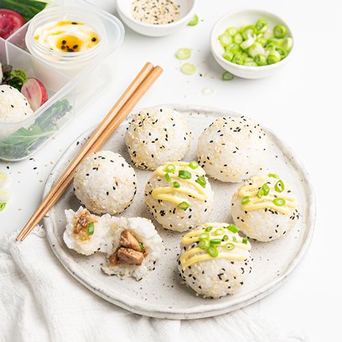 some food is on a plate with chopsticks next to it and bowls of vegetables