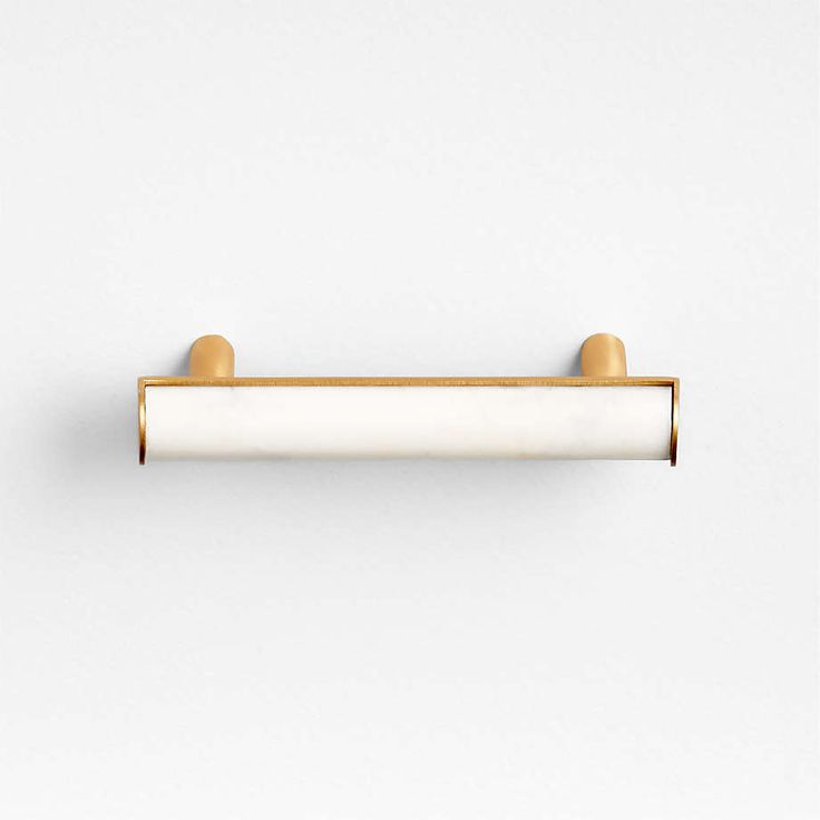 an image of a white and gold door handle on a white wall with no one in it