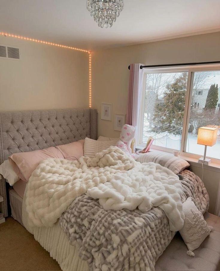 a bedroom with a large bed covered in blankets