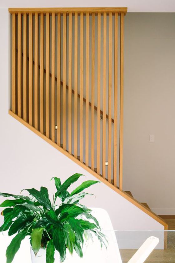 a potted plant sitting on top of a table next to a wooden stair case