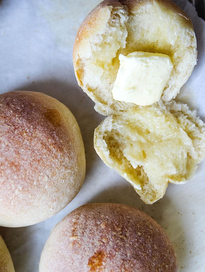 three doughnuts with butter on them sitting on a paper towel